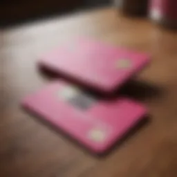 A stylish pink credit card on a wooden table