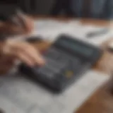 A person analyzing financial documents with a calculator