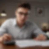 A young adult reviewing loan documents with a calculator